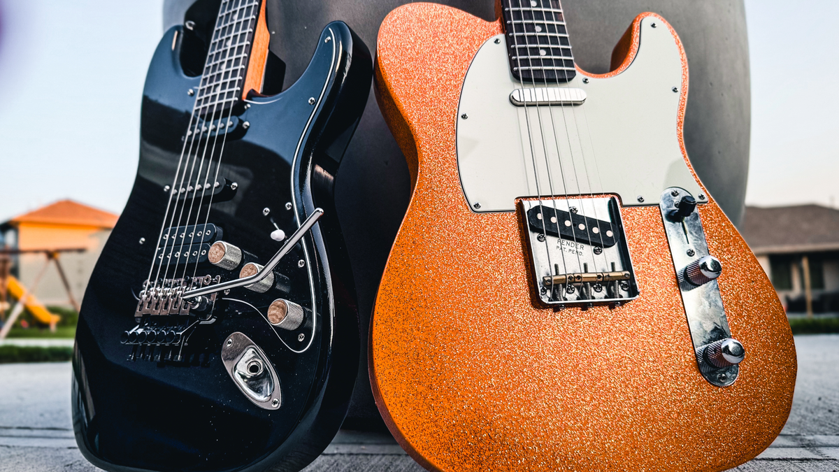Two custom guitars built by JTal Guitars in Elkhorn, NE. One Telecaster style guitar is orange with metallic flake, the other is a Super Strat style all black