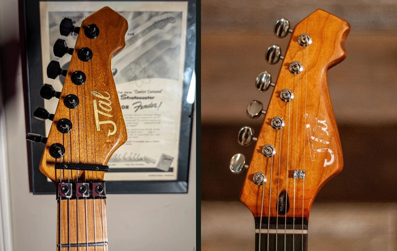 Two JTal headstocks with different outlines, one with black hardware and one with chrome hardware and a worn white logo.